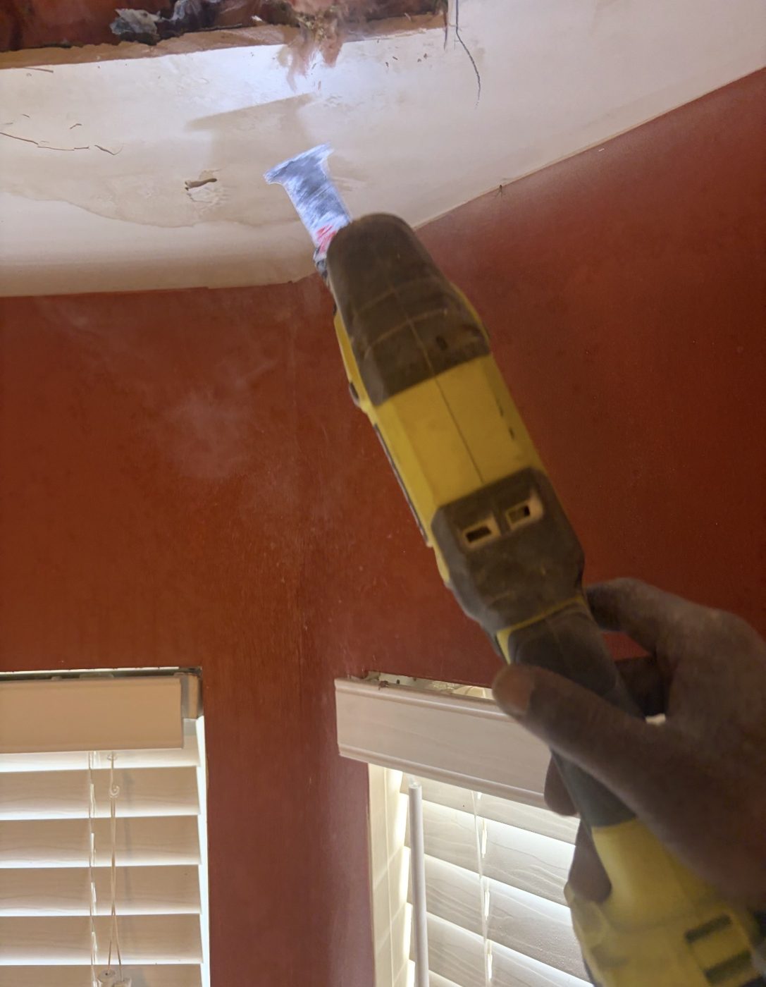 Cutting out water-damaged drywall